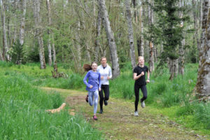 Jemtegaard Middle School eighth-grader Danica Stinchfield (right) and her sister, Alyssa (left), a seventh-grader, run with their mother, Tracey, during a workout session for the school's virtual track and field program. (Contributed photos courtesy of Tracey Stinchfield)