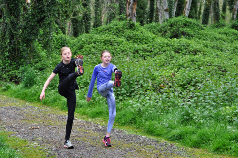 Jemtegaard Middle School eighth-grader Danica Stinchfield (left) and her sister Alyssa, a seventh-grader, run during a workout session for the school&#039;s virtual track and field program.