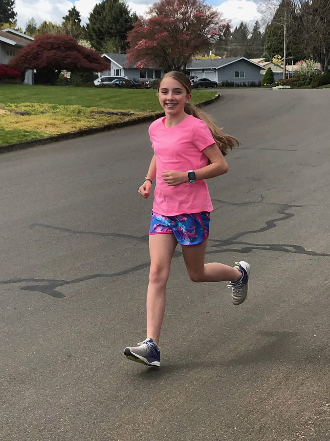 Jemtegaard Middle School sixth-grader Gracie Perry runs near her home as part of her school&#039;s virtual track and field program.