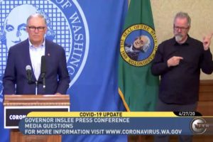 Governor Jay Inslee (left) speaks at a press conference on Monday, April 27. 