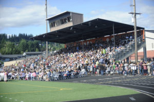 (Post-Record file photos) Crowds gather at Fishback Stadium in June 2019 for the Class of 2019 graduation event. Washougal High plans to hold an in-person graduation ceremony for the Class of 2020 graduates on Aug. 8. District officials say the event will follow COVID-19 distancing restrictions in place at the time.