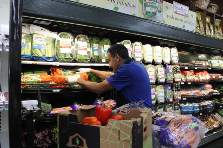 (Kelly Moyer/Post-Record) Ali Alquraisha, owner of Camas Produce, stocks the shelves of his Camas vegetable and fruit market in November 2019, a few days after reopening from a 10-month closure. The Camas market has had to temporarily close again on Friday, May 15, after a delivery vehicle caused damage to the building.