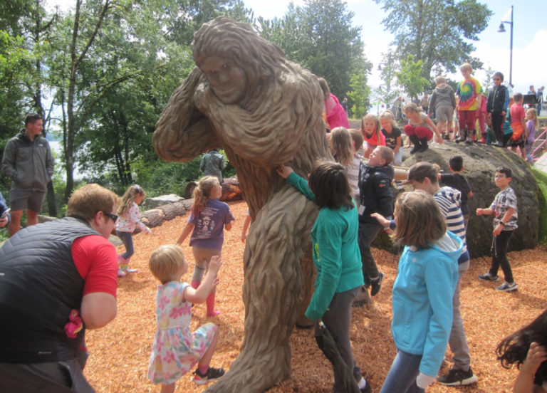 (Post-Record file photo) Children play near Eegah, a sasquatch sculpture, at the natural play area at Washougal Riverfront Park and Trail in June 2019. The Port of Camas-Washougal has canceled its 2020 spring and summer events due to the COVID-19 pandemic, including a birthday party for Eegah set to take place June 5.