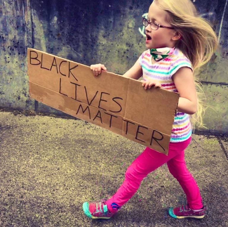 Clara Boswell, 8, holds a Black Lives Matter sign as she walks with her family, including her father, Matt Boswell (not pictured), pastor of the Camas Friends Church, to a peaceful protest in support of the Black Lives Matter movement, held Friday, June 5, in downtown Camas.