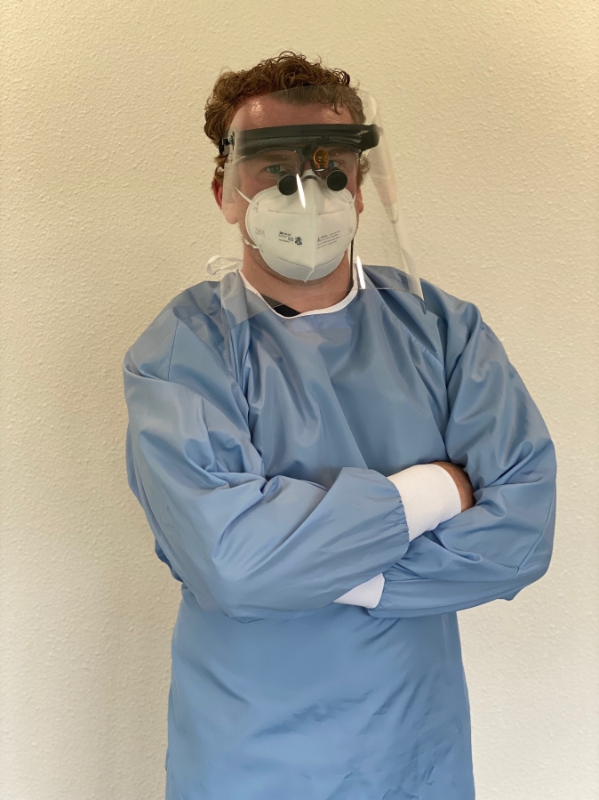 Washougal Family Dental dentist Justin Cochell displays his new face mask and &quot;sneeze shield&quot; on Tuesday, June 9.
