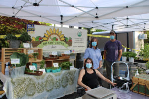 From left to right: Lindsay Inzalaco, Sandy Burgess and Steve Inzalaco, of Shady Grove Farm in Camas, wait for customers at the Camas Farmer's Market on Wednesday, June 10. (Photos by Kelly Moyer/Post-Record)