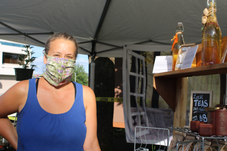 Christina Safford, of The Lady in the Window, a Camas-based business that sells plant starts and herbal teas, shows her selection of teas for sale at the June 10 Camas Farmer&#039;s Market.