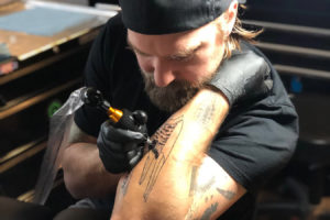 Dan Attoe draws a tattoo on his arm. Attoe, a Washougal resident and world-renowned artist, is now working at 3rd Heart Tattoo in Washougal. (Contributed photo courtesy of Dan Attoe)