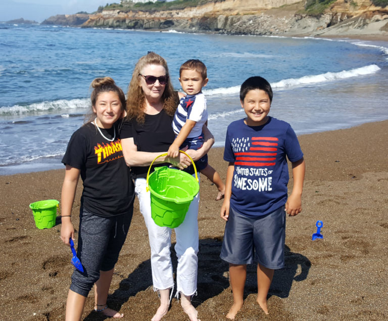 Sandra Ladd, (second from left), is pictured with her grandchildren (left to right): Emma Sasse, Hunter Sasse and Ben Sasse in an undated photo. Ladd, 61, was found murdered in her Washougal home in June. Police and Crime Stoppers of Oregon are asking for the public's help to solve Ladd's murder.
