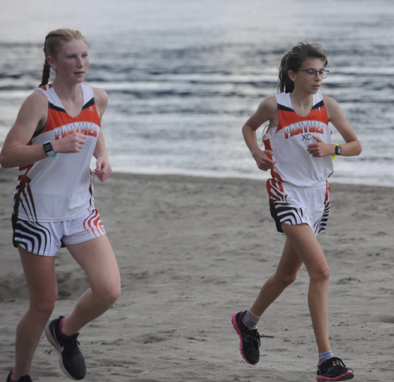 Washougal High School sophomore Savea Mansfield (left) and freshman Sidney Boothby run during a cross country race in September 2019. The 2020 prep cross country season is tentatively scheduled to begin in mid-September.