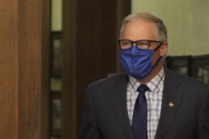 Washington Gov. Jay Inslee wears a face mask as he arrives to speak at a news conference on June 23, 2020, at the Capitol in Olympia. (AP Photo/Ted S. Warren, contributed photo courtesy of The Columbian)