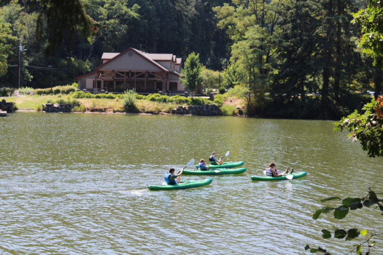 Kayakers paddle past the city of Camas&#039; Lacamas Lake Lodge on Friday, July 31. Public health officials have warned since early June that toxic blue-green algae, which can kill pets and cause severe illness in humans, is present in Camas&#039; Lacamas and Round lakes.