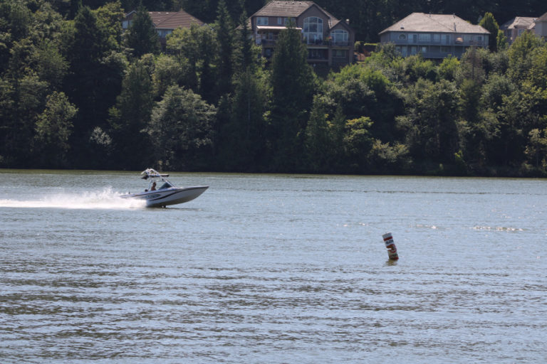 A speed boat races along Lacamas Lake, with Lacamas Shores homes visible in the background, on Friday, July 31.