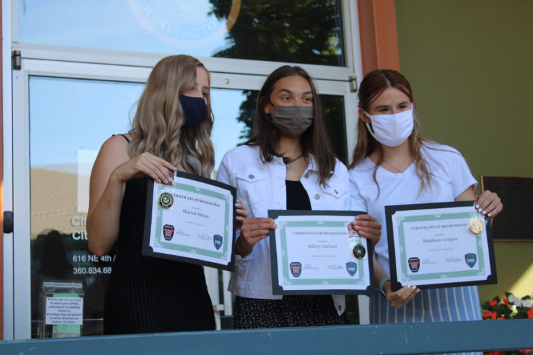 Vancouver teens (left to right) Hannah Salinas, Hillary Darland and Maddison Gregory hold their certificates of recognition at an event held outside Camas City Hall on Aug. 7. Camas' mayor, police chief and fire chief all honored the teens for their heroic actions in July that helped save the lives of a father and his 5-year-old daughter at the Camas Potholes.