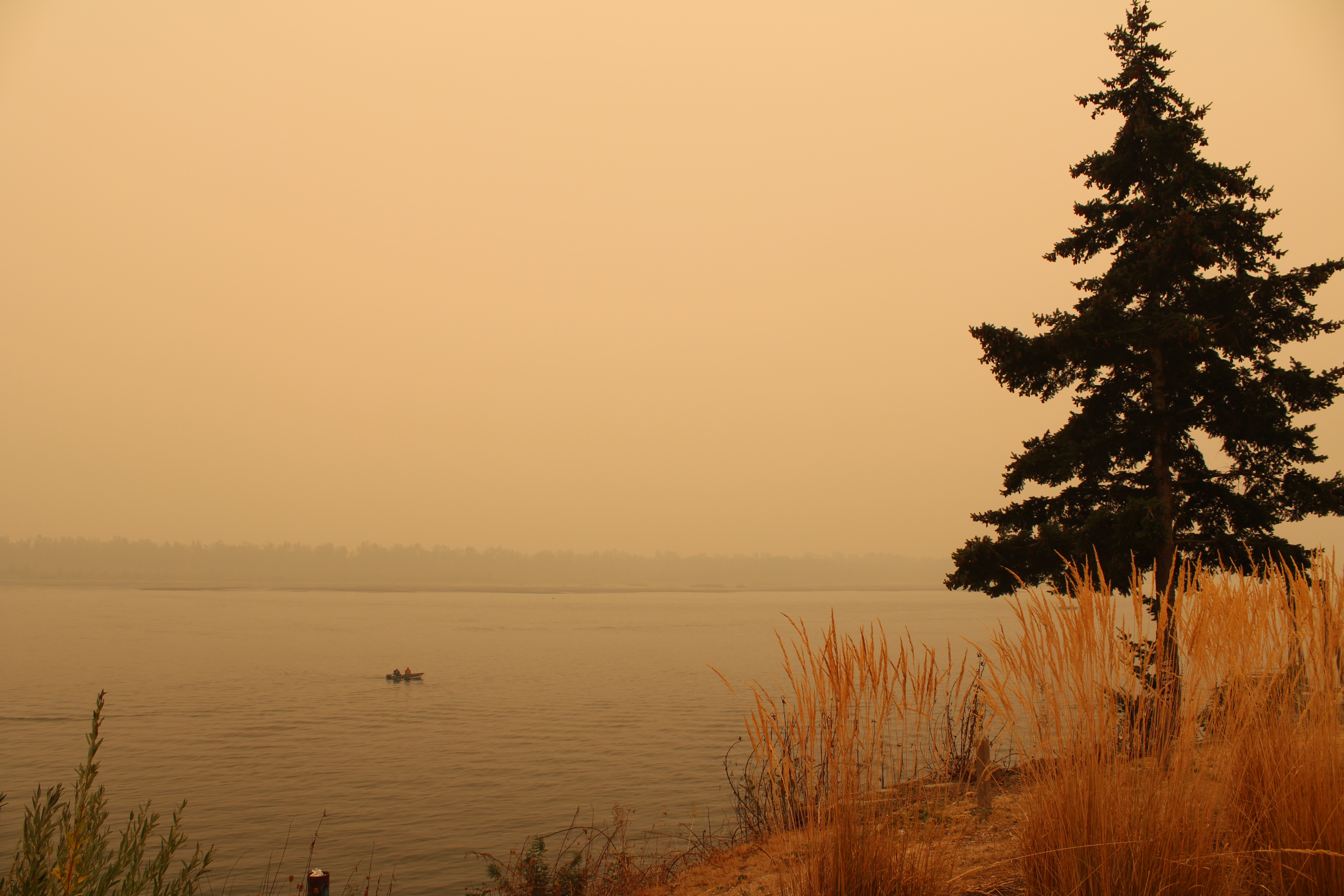 A fishing boat cruises by the Washougal Waterfront Park on Friday, Sept. 11. Smoke from wildfires burning throughout Oregon and California have severely reduced air quality in Camas-Washougal. The air quality in Clark County on Friday was in the hazardous zone, with no relief expected until at least Sunday. (Photos by Kelly Moyer/Post-Record)