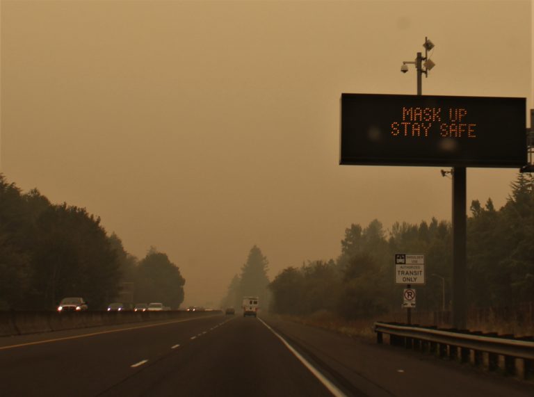 A sign on Highway 14 between Camas and Vancouver reminds drivers to "Mask Up, Stay Safe" on Friday, Sept. 11. Smoke from wildfires burning throughout Oregon and California have made the air quality in Clark County dip into the "hazardous" zone this week.
