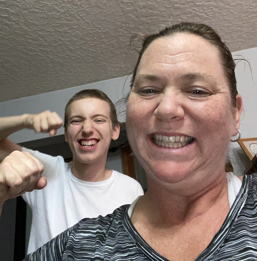 Contributed photo courtesy Jodi Miner 
 Washougal resident Jodi Miner flexes after a workout with her son Austin. "He's one of the main reasons I do it," Miner said.