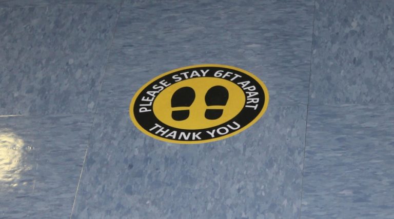 Doug Flanagan/Post-Record 
 Stickers on the floor of the cafeteria at Gause Elementary School remind students to maintain social distancing.