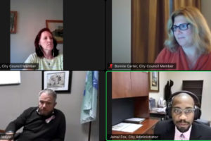 Camas City Administrator Jamal Fox (lower right) speaks during a remote city council workshop on Oct. 5, while Camas Mayor Barry McDonnell (lower left) and council members Melissa Smith (upper left) and Bonnie Carter (upper right) look on. (Screenshot by Kelly Moyer/Post-Record)