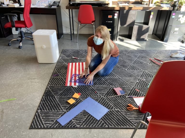 Reed Creative graphic designer and illustrator Kyla Friedrichsmeyer creates an American flag, customized to fit the interior of the &quot;O&quot; letterform in the Washougal marketing firm&#039;s &quot;VOTE&quot; sign. &quot;It will hang vertically so we are making certain the flag section is in proper orientation from the street view,&quot; said Reed Creative owner Lori Reed.