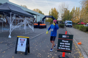 A runner drinks water during the Scary Run event, held Oct. 31 in Washougal.  The event drew 600 participants for 5K and 10K runs. (Shelly Atwell/Post-Record)