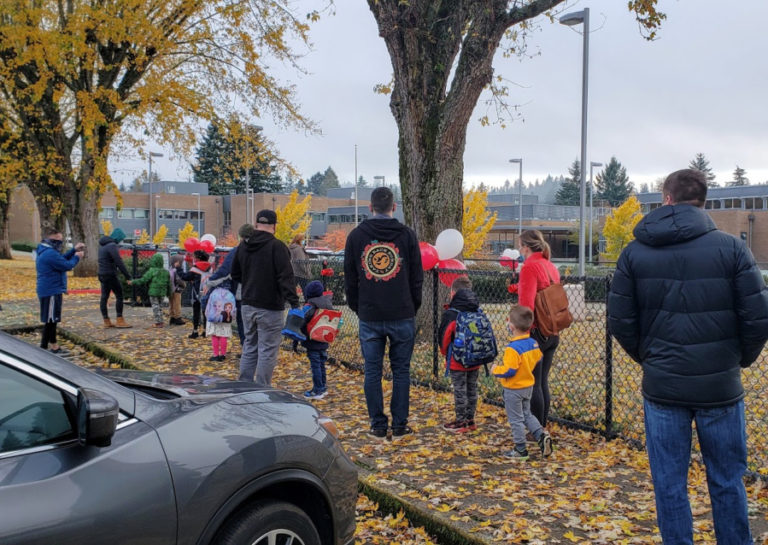 Kindergarten students and their parents/caregivers stand in line outside Helen Baller Elementary School in Camas on Monday, Nov. 9, the first day of in-person kindergarten classes in the district since the COVID-19 pandemic began in March 2020.