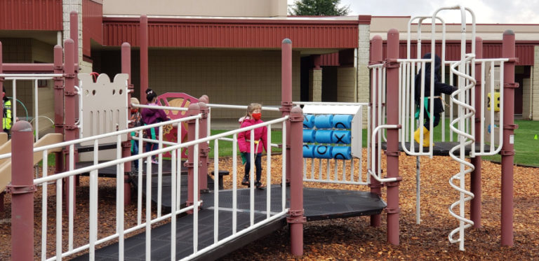 Kindergarten students play at recess at Dorothy Fox Elementary School in Camas on Monday, Nov. 9. The Camas School District has reopened classrooms for small groups of kindergarten students, but is taking several COVID-19 precautions, including the required wearing of face coverings and having students stay in their small cohort groups during the day, even during recess.