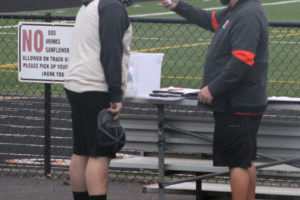 Washougal football coach Terry Hyde (right) takes the temperature of senior lineman Mason Heath during a practice session at Fishback Stadium on Nov. 12, 2020. (Photos by Doug Flanagan/Post-Record)