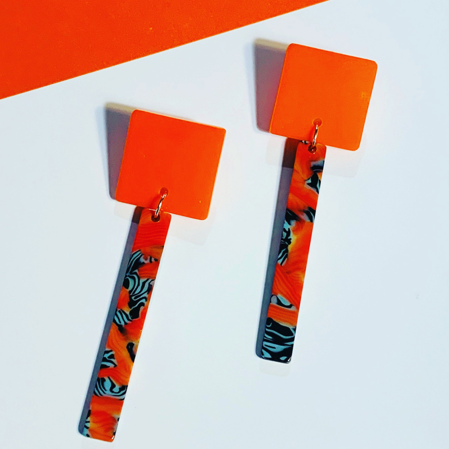 A pair of orange plexiglass earrings crafted by Camas artist India de Landa (Contributed by Tamara Dinius)