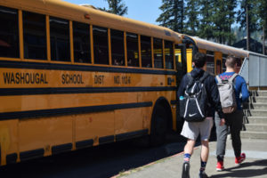 Washougal students walk past school buses in the Washougal School District in 2018. (Post-Record file photo)