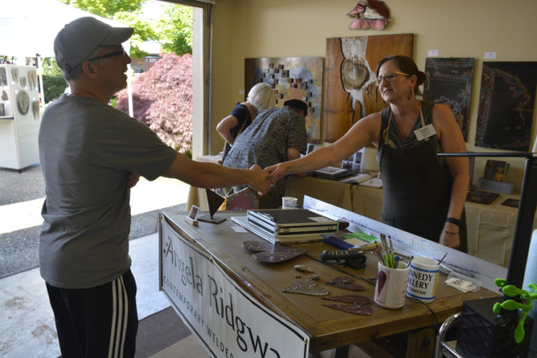 Former Washougal resident Angela Ridgway greets an attendee during the 2019 Washougal Studio Artists Tour.