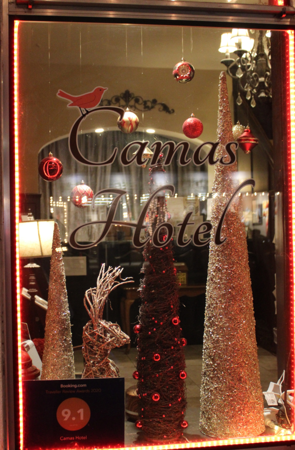 A holiday display shines inside the front window of the Camas Hotel on Friday, Dec. 4, 2020.