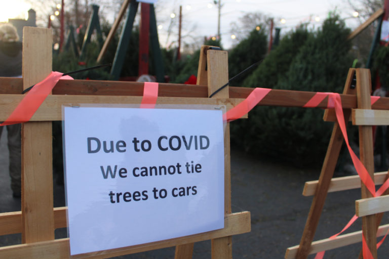 A sign at the Boy Scouts tree lot in downtown Camas speaks to COVID-19 restrictions in place this year, on Nov. 27, 2020.