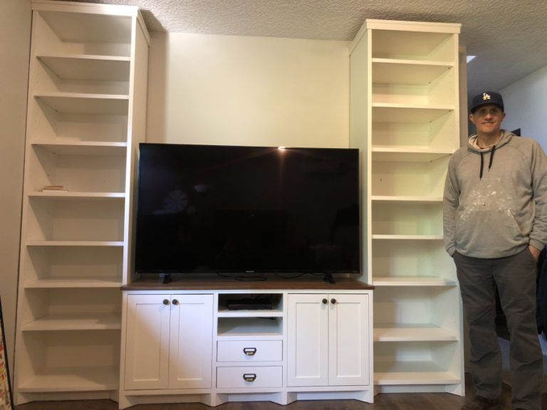 Washougal resident Greg Lewis stands next to an entertainment center that he built.