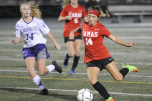 Camas High School soccer player forward Kiya Gramps scores a goal during a game at Doc Harris Stadium in October 2019. (Post-Record file photos)