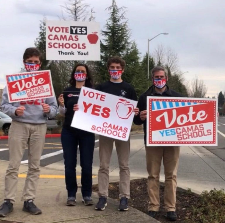Tamara Herdener (second from left) and her family, including her twin sons, both seniors at Camas High School, hold signs urging Camas School District voters to approve two replacement levies in the Feb. 9, 2021 special election. The levies make up nearly 20 percent of the school district&#039;s budget and help fund sports, extracurricular activities, special education programs, technology, school building maintenance, school nursing staff, accelerated learners&#039; programs and allow the district to hire additional educators to reduce class sizes.