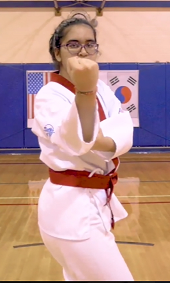 Camas Soo Bahk Do student Elena Chaundry performs a &#039;hyung&#039; maneuver during her performance for the 2020 Soo Bahk Do Moo Duk Kwan Federation National Festival.
