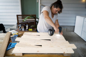 Washougal resident Jackie Gollbach builds a wooden sign during the filming of the first video for her new YouTube channel, "Nail Polish and Power Tools." (Contributed photo courtesy of Jackie Gollbach)