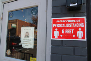 Signs posted outside a downtown Camas business on Northeast Third Avenue in November 2020 advertise required COVID-19 mitigation protocols. (Kelly Moyer/Post-Record files)