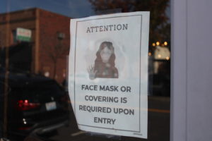 A sign posted to the front of A Beer at a Time in downtown Camas in October 2020 tells patrons they must wear a face covering inside the restaurant. (Kelly Moyer/Post-Record file photo)