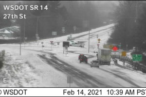 Drivers navigate a snow-covered Highway 14 near the Washougal roundabout at 27th Street at 10:39 a.m. Sunday, Feb. 14, 2021. (Photo courtesy of WSDOT)