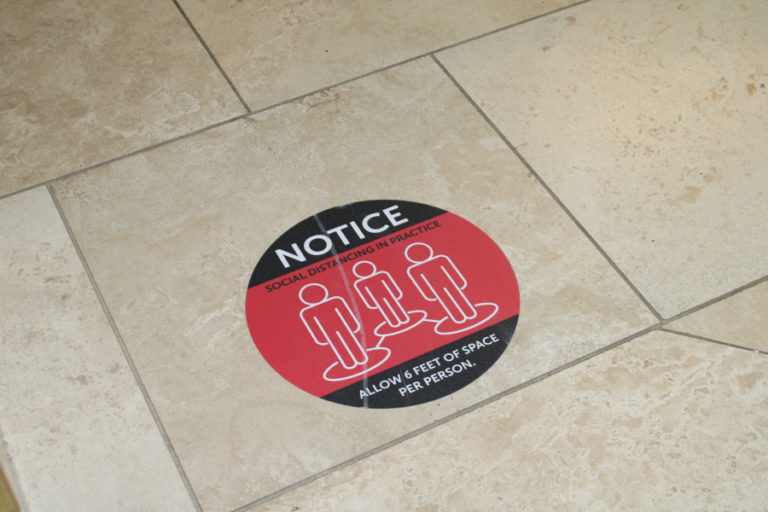 Stickers on the floor of the Camas Public Library point out physical-distancing rules on Friday, March 5, 2021. The library is set to reopen its indoor services on March 15, 2021, after a nearly yearlong closure due to the COVID-19 pandemic.