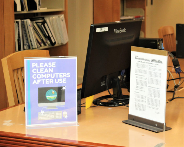 A sign at the Camas Public Library asks patrons to clean their computers after using, on Friday, March 5, 2021. The library will reopen indoor services on March 15, 2021, after a yearlong closure due to the COVID-19 pandemic.