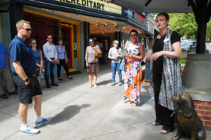 Carrie Schulstad (right), executive director of the Downtown Camas Association, talks about Camas' downtown businesses during the Columbia River Economic Development Council's Main Street Day tour on July 13, 2018. (Post-Record file photo)