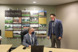 Camas School District Superintendent Jeff Snell (left) talks to the district's director of elementary education, Doug Hood (right) after a special Camas School Board meeting held Thursday, April 1, 2021. (Kelly Moyer/Post-Record)