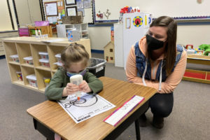Brittni Nester, a preschool teacher at Gause Elementary School, watches student Madisyn Deaver work on a project in November 2020. (Contributed photo courtesy of Washougal School District)