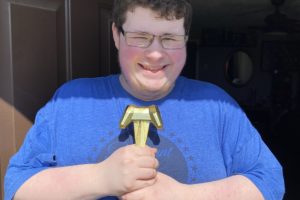 Washogual High School junior Aidan Davis-Cosmo holds a trophy after participating on the school's Unified teams which took first and third place their division at the Special Olympics Washington's Virtual Winter Games e-gaming competition. (Contributed photo courtesy Washougal School District)