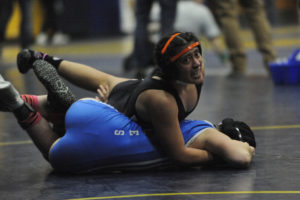 Washougal's Melina Aguilar (top) scraps for positioning in her opening-round match at the Region 3 girls wrestling meet in Kelso, Wash., on Feb. 15, 2020. Aguilar, a two-time Mat Classic qualfier, is the Panthers' 2021 captain. (Post-Record file photo)