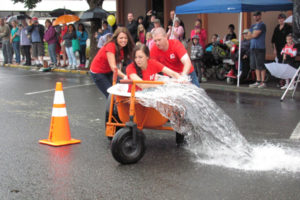 Ice-cold water spills from a bathtub in the 2017 Camas Days' bathtub races. (Post-Record file photo)