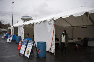 Pharmacist Melissa Malachi waits for the next vehicle while helping out at the vaccination site at Tower Mall on March 5, 2021. (Courtesy of Amanda Cowan/The Columbian)